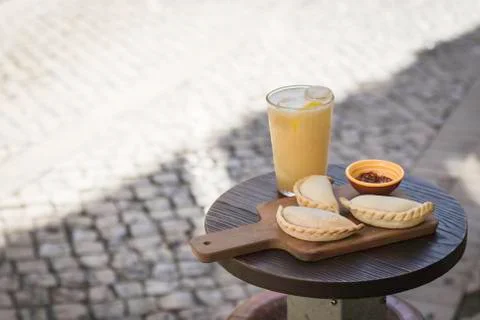 Small chopping board displaying typical food from Portugal and South America, Stock Photos
