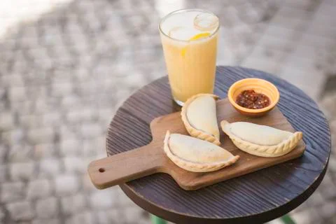 Small chopping board displaying typical food from Portugal and South America, Stock Photos