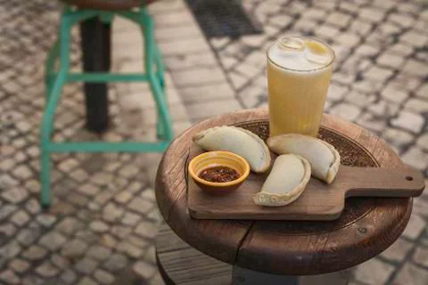 Small chopping board displaying typical food from Portugal and South America, Stock Photos