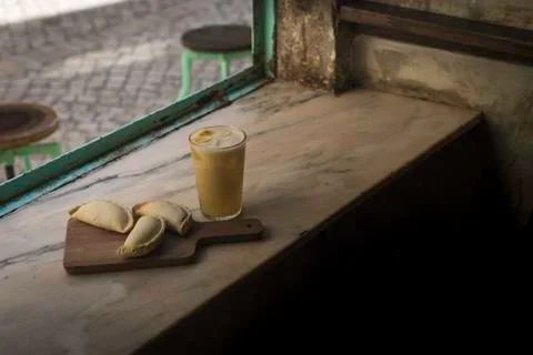 Small chopping board displaying typical food from Portugal and South America, Stock Photos