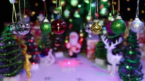 Small Christmas decorations swing on a half-blurred Christmas background Stock Footage 255912684