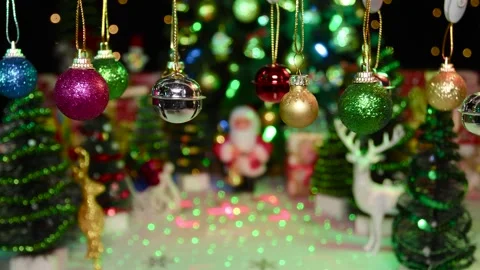 Small Christmas decorations swing on a half-blurred Christmas background Stock Footage 255912690