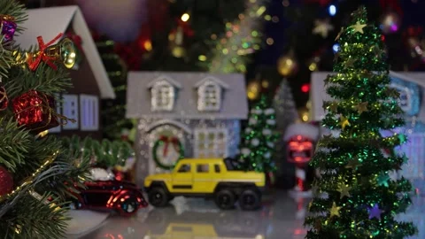 In a small Christmas town two yellow cars drive up to the houses Stock Footage 317299570