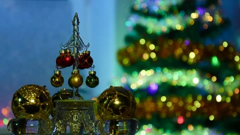 A small Christmas tree among Christmas balls rotates Stock Footage 258331908