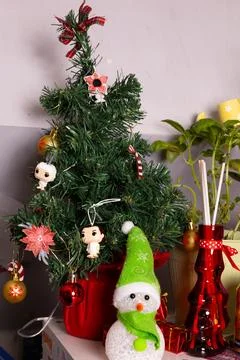 Small Christmas tree with decorations on a table in a room Stock Photos