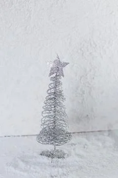 A small Christmas tree on a light background Stock Photos