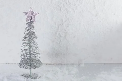A small Christmas tree on a light background Stock Photos
