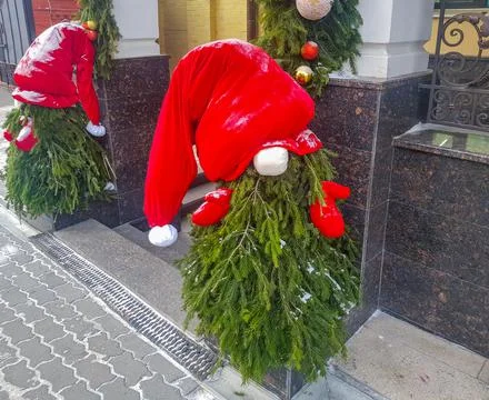 A small Christmas tree is made in the form of Santa Claus with a hat and mitt Stock Photos