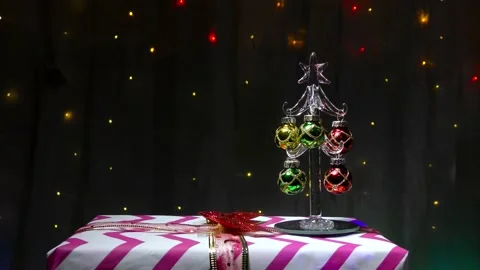 A small Christmas tree stands on a New Year's gift Stock Footage 144609736
