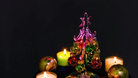 Small christmas tree surrounded by christmas candles and balls Stock Footage 162628253