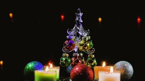 A small Christmas tree surrounded by Christmas candles and balls Stock Footage 164792591