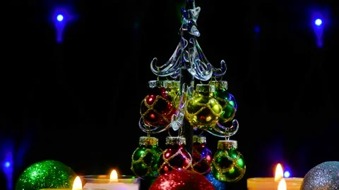A small Christmas tree surrounded by Christmas candles and balls Video stock 164792609
