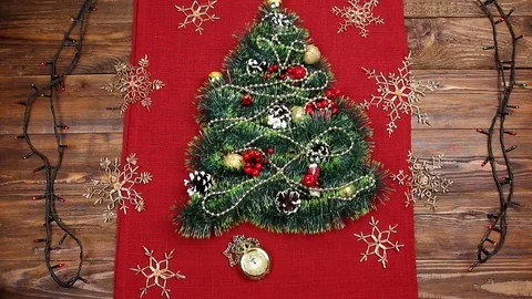 A small Christmas tree of tinsel, nuts, ribbons and ornaments. Gift for a Stock Footage 83886882