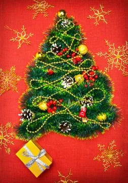 A small Christmas tree of tinsel, nuts, ribbons and ornaments. Gift for a Stock Photos