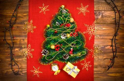 A small Christmas tree of tinsel, nuts, ribbons and ornaments. Gift for a Stock Photos