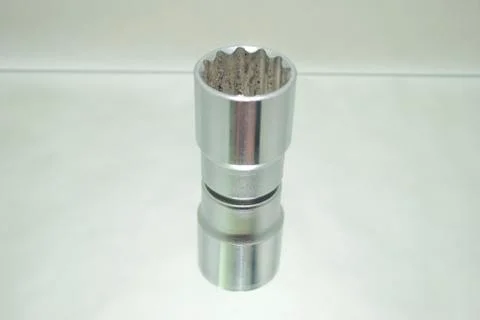 Small chrome ratchet socket on mirror close-up Stock Photos