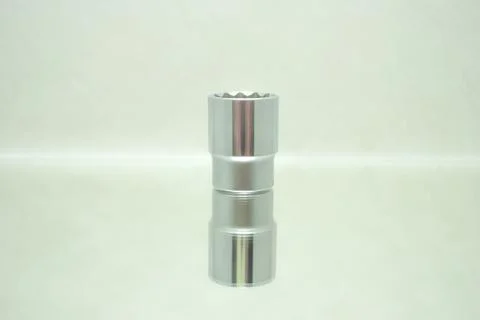 Small chrome ratchet socket on mirror close-up Stock Photos