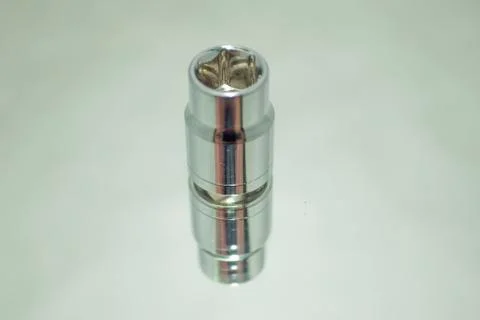 Small chrome ratchet socket on mirror close-up Stock Photos