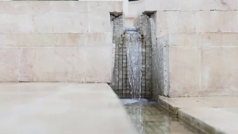 Small city fountain - water falling on marble steps Stock Footage