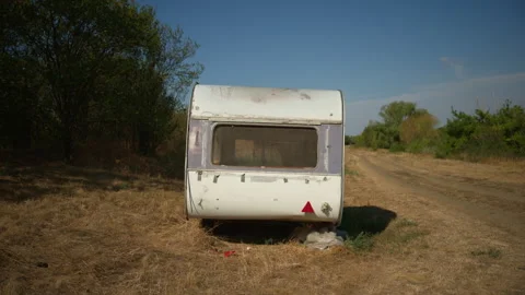 Small classic caravan parked in a sunny countryside meadow. Concept of outd.. Stock Footage 345564981