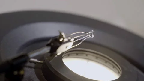 Small classic round diamond is held next to microscope to be examined and clean Stock Footage 154280531