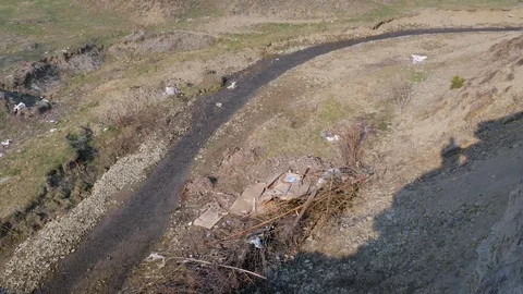Small clean creek polluted with trash Stock Footage 105629856