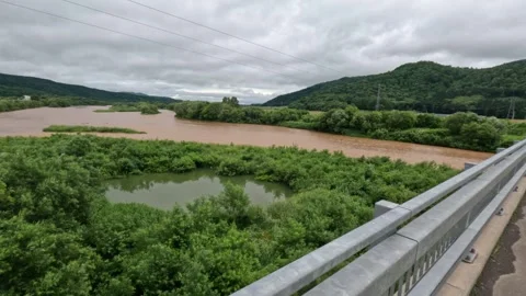 A small clean lake surrounded by dirty river water. POV a hand is pointing Stock Footage 252705939