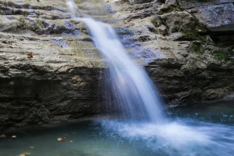 Small clean mountain river waterfall and green overgrown river banks Stock Photos