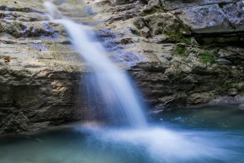 Small clean mountain river waterfall and green overgrown river banks Stock Photos
