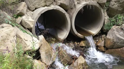 Small clean river flowing through concrete pipes Stock Footage 344795333