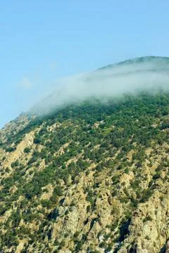 Small cloud born on the top of cliff Stock Photos