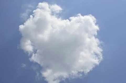 A small cloud in the shape of a heart against the blue sky Stock Photos