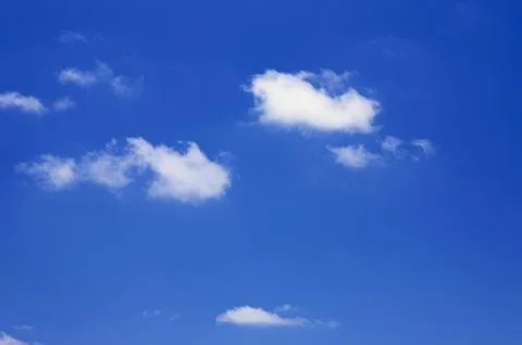 Small clouds in a blue sky Stock Photos