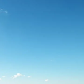 Small clouds on blue sky Stock Photos