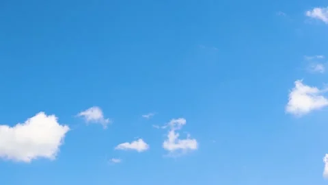 Small clouds forming and moving on a blue sky on sunny summer day timelapse Stock Footage 247435574