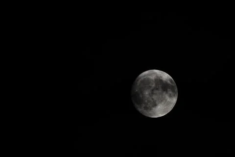 Small clouds obscured the full moon in the sky Stock Photos