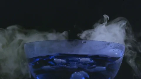 Small clouds of smoke rise form bubbling bowl in slow motion Stock Footage 70706309