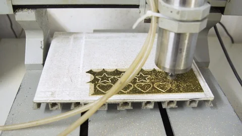 Small CNC engraving machine milling a golden metal plate, dolly shot Stock Footage 101258164