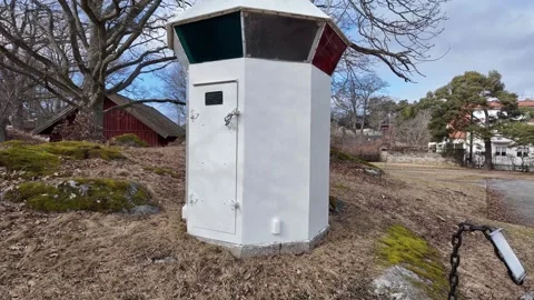 A small coastal navigation beacon stands quietly in a rural Scandinavian. Stock Footage 331316397