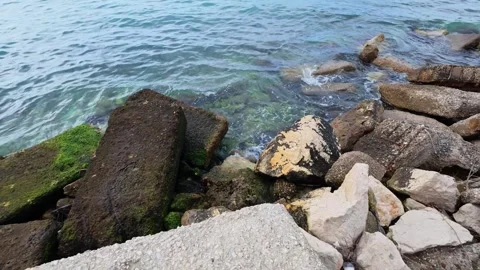 Small Coastal Waves Hitting Rocks and Platform Stock Footage 306318256