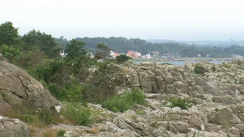 Small coastel town behind rocks Stock Footage 86356861