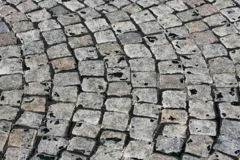 Small cobblestone sidewalk made of cubic stones structured background Foto stock