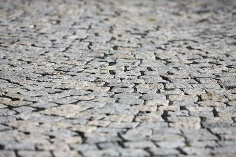 Small cobblestone sidewalk made of cubic stones structured background Stock Photos
