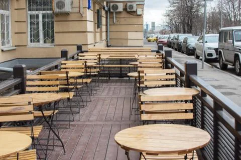 Small coffee in the centre tiny wooden tables and chairs Stock Photos