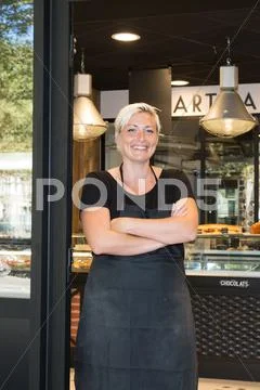 Small coffee shop owner standing in front of store. Stock Photos