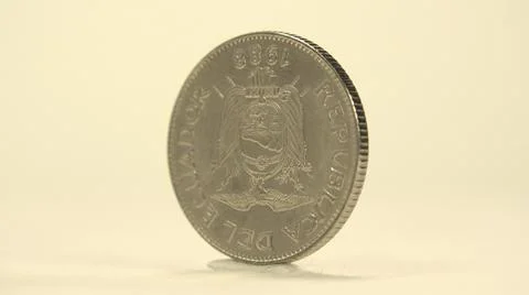 Small Coin Being Spun In Clockwise Motion To Show Off Both Sides Of It Stock Photos
