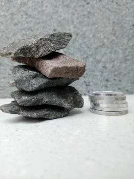 Small Coin Stack Beside a Pile of Crushed Stones 스톡 사진