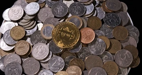 Small coins are slides on rotating platform, fiat money, bitcoin coin on top Stock Footage 120400148