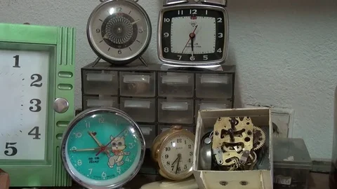 Small collection of alarm clocks in clock repairer shop Stock Footage 77232529