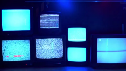 A small collection of seven old TVs with No signal Stock Footage 155985129
